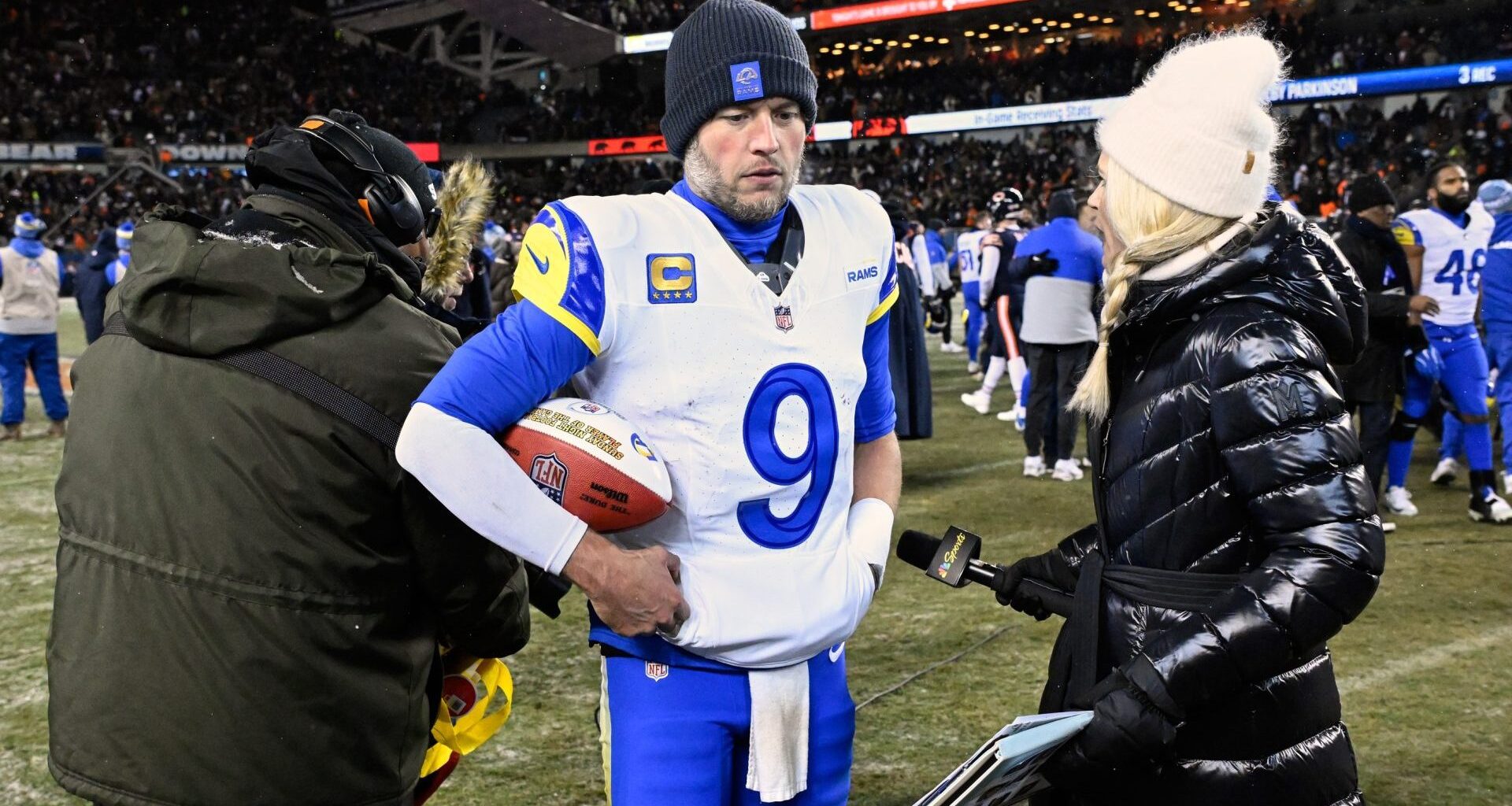 Jan 18, 2026; Chicago, IL, USA; Los Angeles Rams quarterback Matthew Stafford (9) holds a game ball as he is interviewed by NBC sideline reporter Melissa Stark after a NFC Divisional Round game against the Chicago Bears at Soldier Field. Mandatory Credit: Matt Marton-Imagn Images