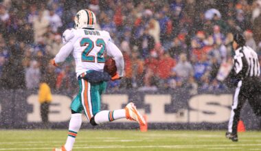 Dec 18, 2011; Orchard Park, NY, USA; Miami Dolphins running back Reggie Bush (22) runs for a touchdown against the Buffalo Bills during the second half at Ralph Wilson Stadium.