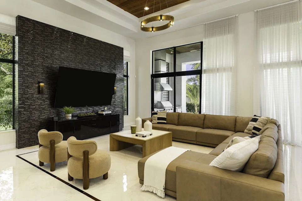 Living space with an L-shaped couch in a home in Florida bought by NFL player Sterling Shepard