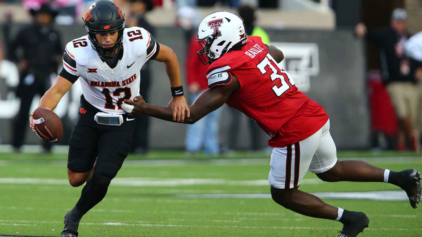 Texas Tech Red Raiders defensive end David Bailey (31) pressures Oklahoma State Cowboys quarterback Noah Walters (12) in the second half at Jones AT&T Stadium.
