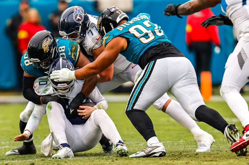 Jacksonville Jaguars defensive end Dawuane Smoot (98) and Jacksonville Jaguars defensive end Matt Dickerson (93) sack Tennessee Titans quarterback Brandon Allen (10) during the fourth quarter in an NFL football matchup at EverBank Stadium, Sunday, Jan. 4, 2026, in Jacksonville, Fla. The Jaguars defeated the Titans 41-7 [Doug Engle/Florida Times-Union]