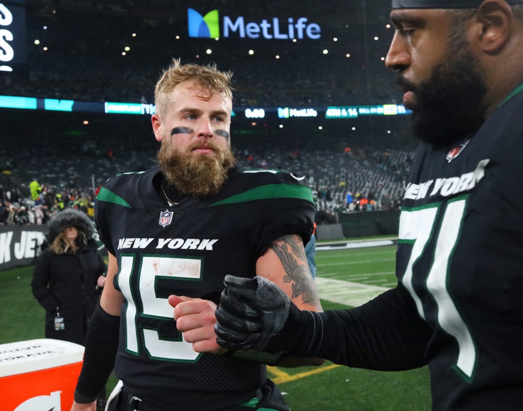 Jets offensive tackle Duane Brown and quarterback Chris Streveler exchanging a fist bump after a game.