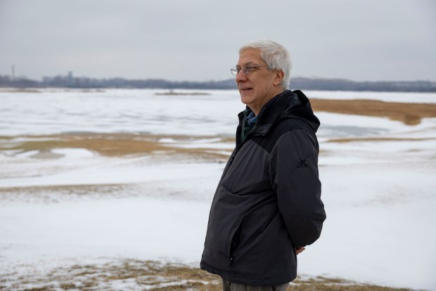 Paul Botts, president and executive director of the Wetland Initiative, looks out on the landscape Feb. 2, 2026, at Harborside Marsh Pond on Chicago's Far South Side. The wetlands alongside a golf course, frozen in the winter, will be restored after past use by industry. (Brian Cassella/Chicago Tribune)