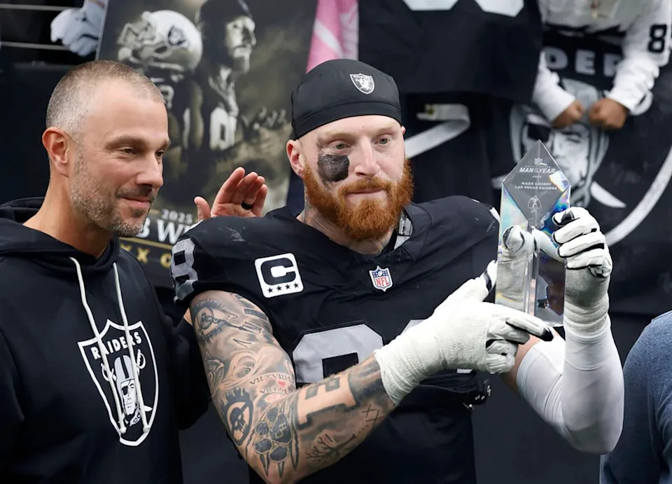 Las Vegas Raiders defensive end Maxx Crosby (98) stands with John Spytek, left, after receiving the Walter Payton Man of the Year Award. TNS