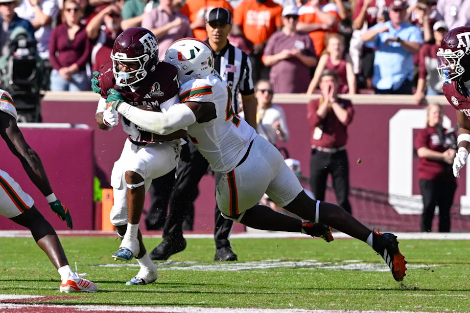 Miami Hurricanes defensive lineman Rueben Bain Jr. (4) tackles Texas A&M Aggies wide receiver KC Concepcion (7).© Jerome Miron-Imagn Images