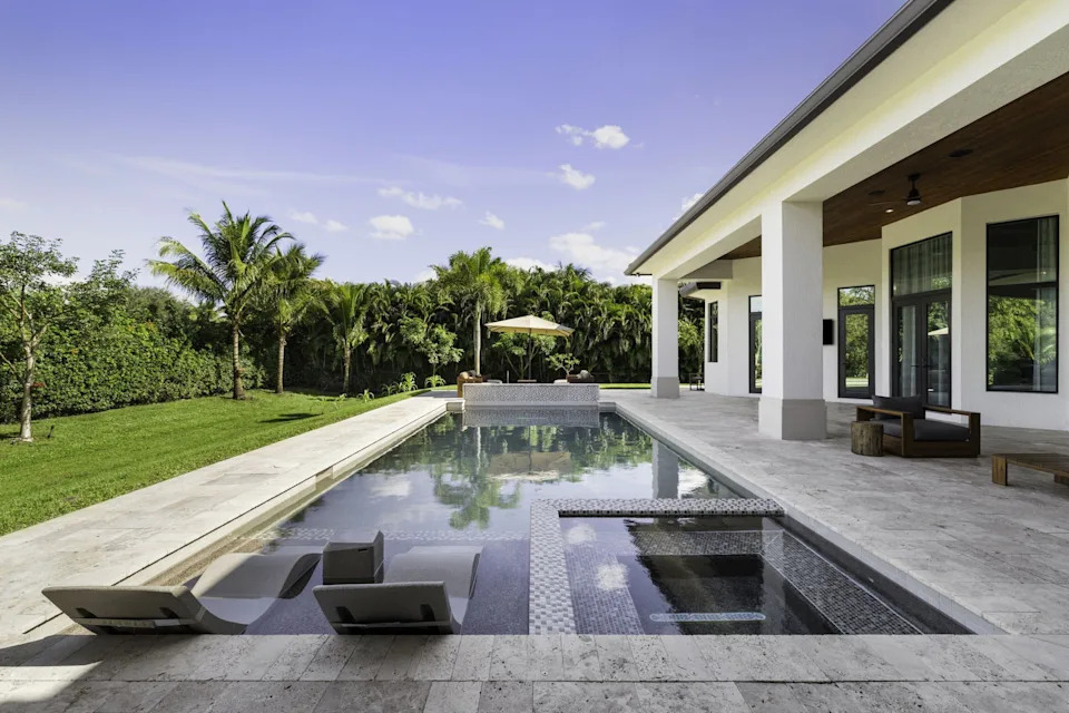 Pool with lounge chairs at a home in Florida bought by NFL player Sterling Shepard