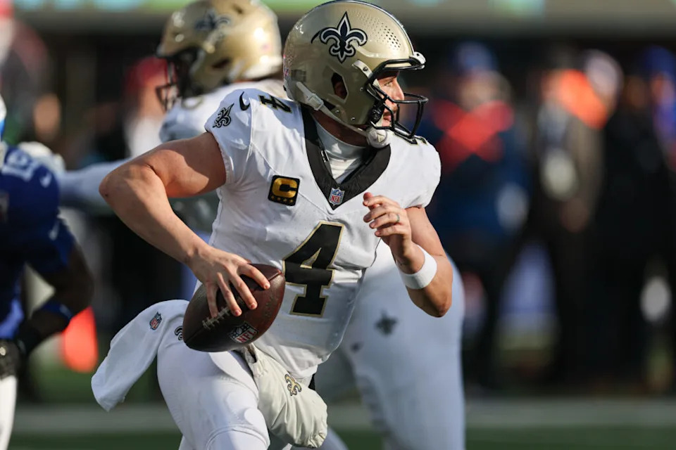 Dec 8, 2024; East Rutherford, New Jersey, USA; New Orleans Saints quarterback Derek Carr (4) scrambles during the first half against the New York Giants at MetLife Stadium. Mandatory Credit: Vincent Carchietta-Imagn Images