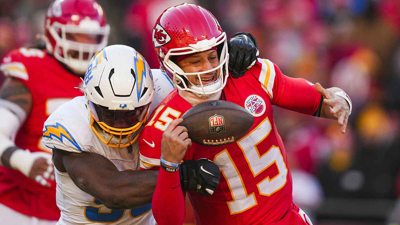 Los Angeles Chargers linebacker Odafe Oweh (98) sacks Kansas City Chiefs quarterback Patrick Mahomes (15) during the second half at GEHA Field at Arrowhead Stadium.