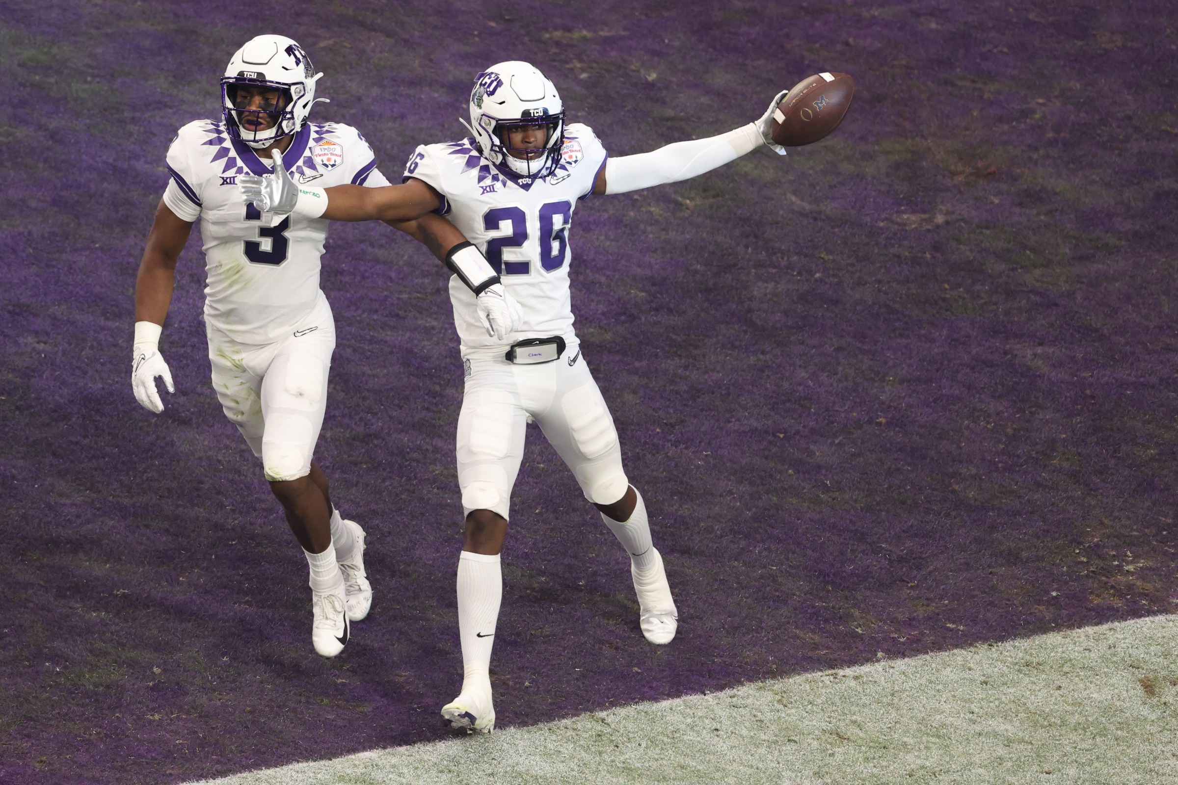 GLENDALE, ARIZONA - DECEMBER 31: Bud Clark #26 of the TCU Horned Frogs celebrates after returning an interception for a touchdown during the first quarter against the Michigan Wolverines in the Vrbo Fiesta Bowl at State Farm Stadium on December 31, 2022 in Glendale, Arizona. (Photo by Christian Petersen/Getty Images)