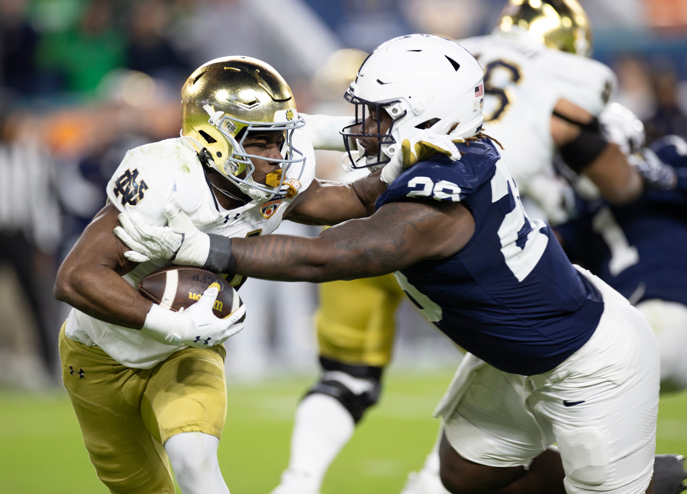 MIAMI GARDENS, FLORIDA - JANUARY 9: Jadarian Price #24 of Notre Dame Fighting Irish gets tackled by Zane Durant #28 of Penn State Nittany Lions during the game at Hard Rock Stadium on January 9, 2025 in Miami Gardens, Florida. (Photo by Michael Pimentel/ISI Photos/Getty Images)