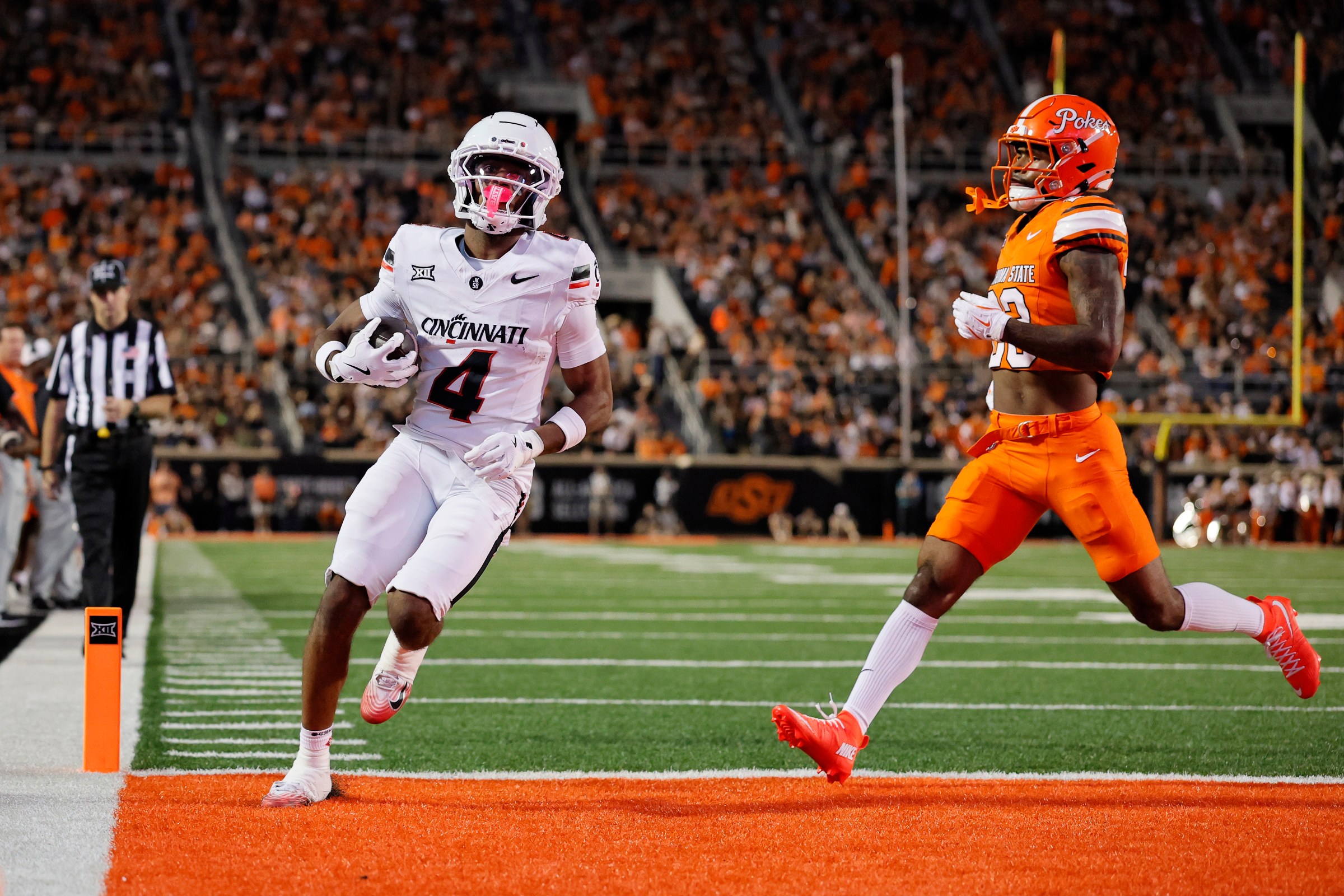 STILLWATER, OK - OCTOBER 18: Wide receiver Cyrus Allen #4 of the Cincinnati Bearcats scores on a 12-yard touchdown catch untouched by safety Kenneth Harris #23 of the Oklahoma State Cowboys with 13 seconds left in the second quarter at Boone Pickens Stadium on October 18, 2025 in Stillwater, Oklahoma. (Photo by Brian Bahr/Getty Images)