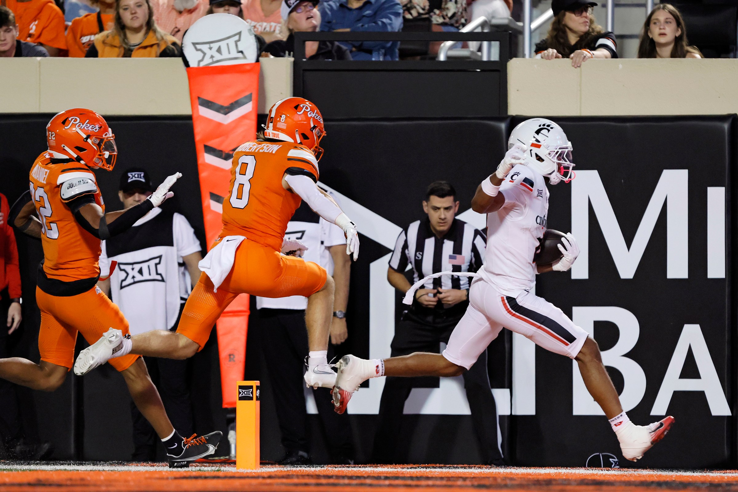 STILLWATER, OK - OCTOBER 18: Wide receiver Cyrus Allen #4 of the Cincinnati Bearcats scores his second touchdown on a 14-yard run against safety Parker Robertson #8 of the Oklahoma State Cowboys to start the second quarter at Boone Pickens Stadium on October 18, 2025 in Stillwater, Oklahoma. Cincinnati won 49-17. (Photo by Brian Bahr/Getty Images)