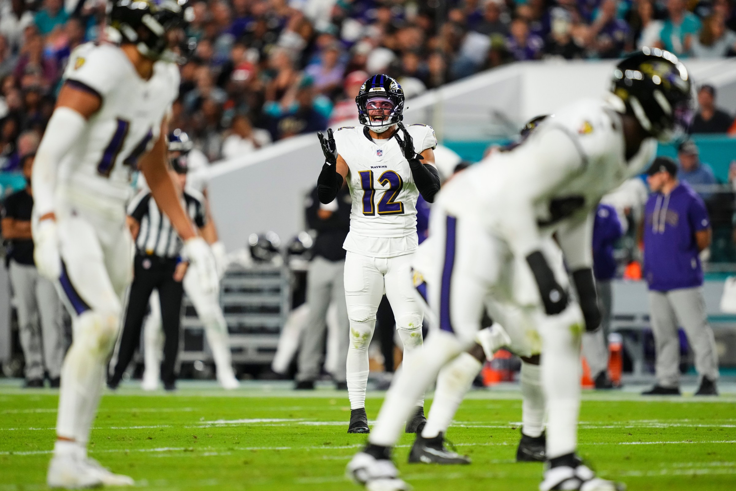 MIAMI GARDENS, FL - OCTOBER 30: Alohi Gilman #12 of the Baltimore Ravens looks on from the field during an NFL football game against the Miami Dolphins at Hard Rock Stadium on October 30, 2025 in Miami Gardens, Florida. (Photo by Cooper Neill/Getty Images)