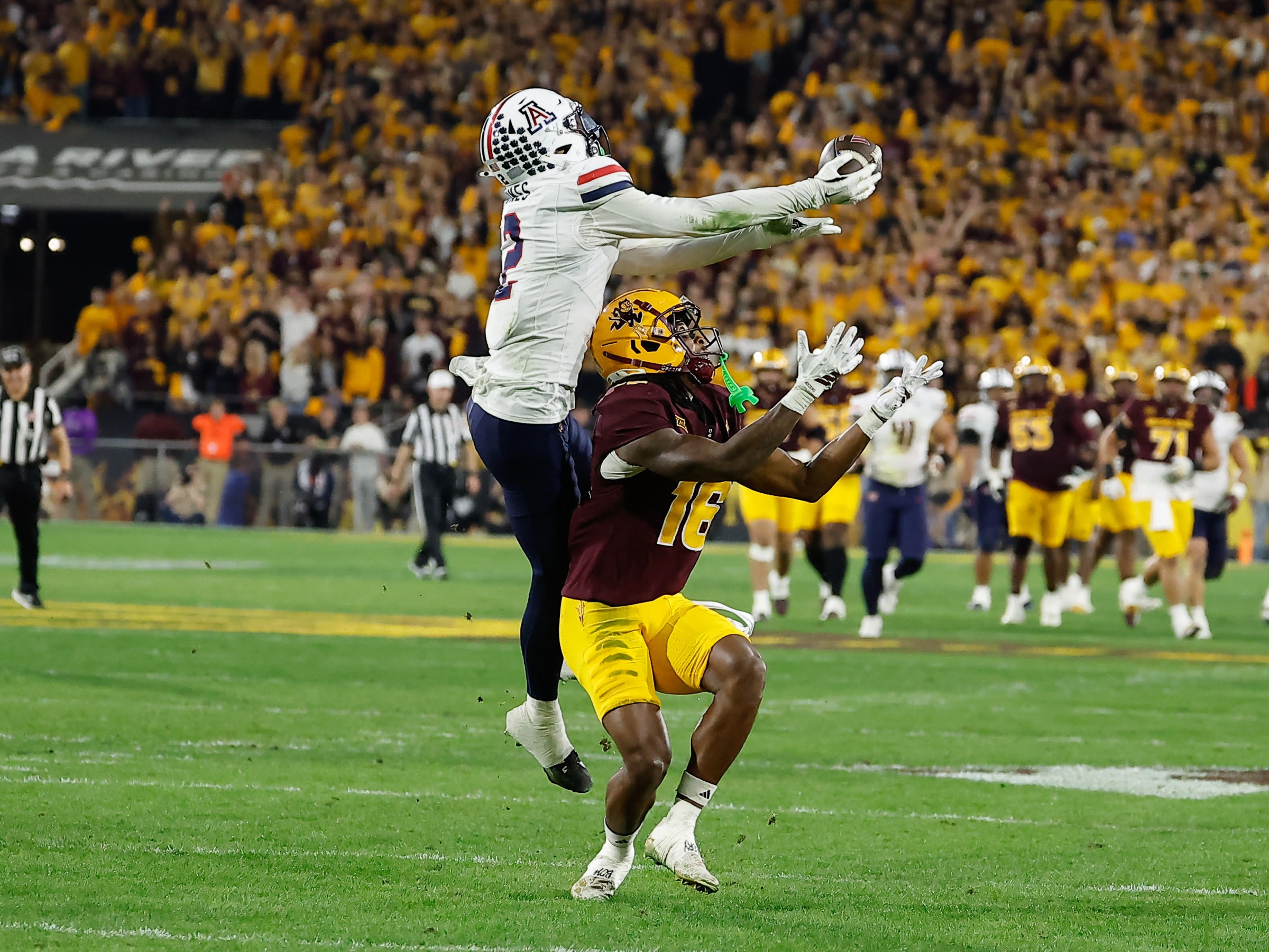 TEMPE, AZ - NOVEMBER 28: Arizona Wildcats defensive back Treydan Stukes (2) intercepts a pass to Arizona State Sun Devils wide receiver Jalen Moss (18) during the college football game between the Arizona Wildcats and the Arizona State Sun Devils on November 28, 2025 at Mountain America Stadium in Tempe, Arizona. (Photo by Kevin Abele/Icon Sportswire via Getty Images)