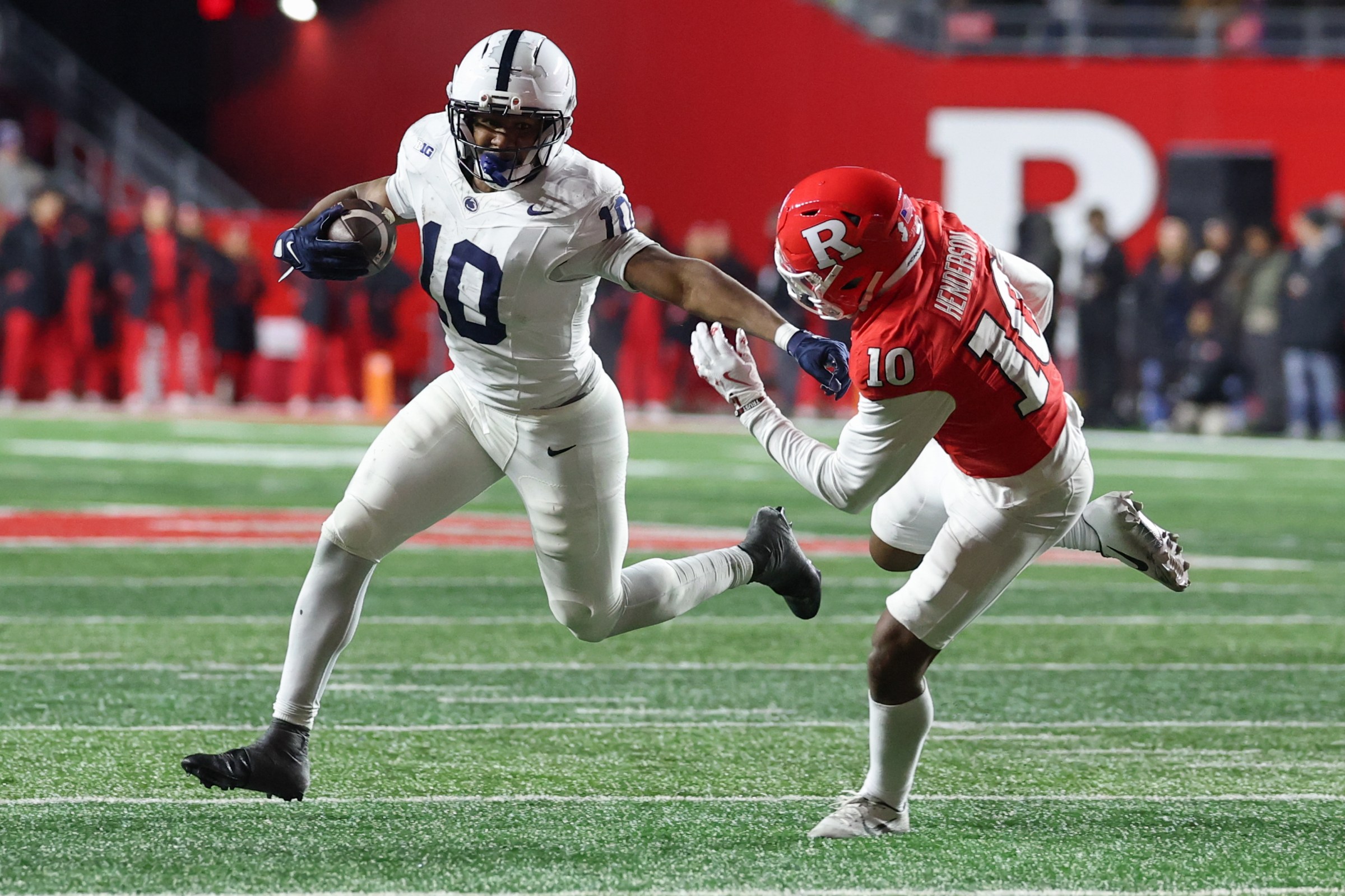 PISCATAWAY, NEW JERSEY - NOVEMBER 29: Nicholas Singleton #10 of the Penn State Nittany Lions runs with the ball as Jacobie Henderson #10 of the Rutgers Scarlet Knights attempts to tackle him during the second half at SHI Stadium on November 29, 2025 in Piscataway, New Jersey. (Photo by Ed Mulholland/Getty Images)