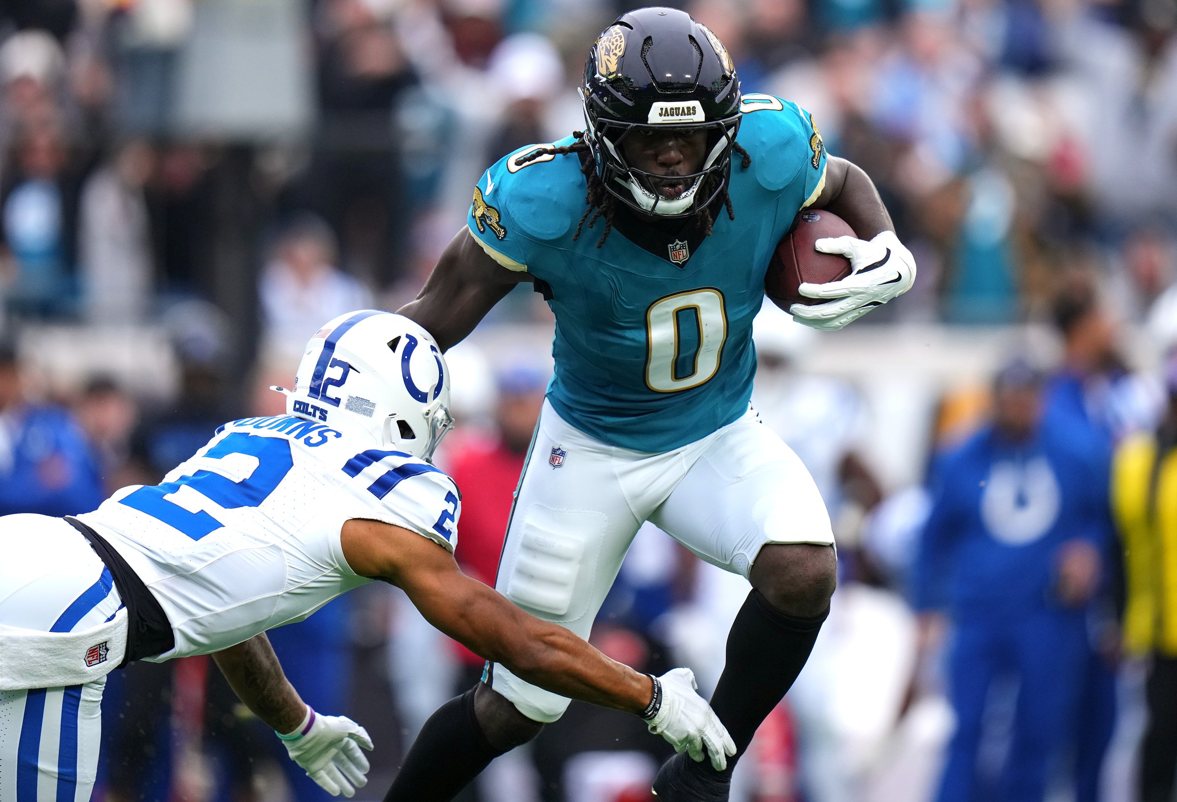 JACKSONVILLE, FLORIDA - DECEMBER 07: Devin Lloyd #0 of the Jacksonville Jaguars carries the ball after an interception defended by Josh Downs #2 of the Indianapolis Colts during the first quarter at EverBank Stadium on December 07, 2025 in Jacksonville, Florida. (Photo by Rich Storry/Getty Images)
