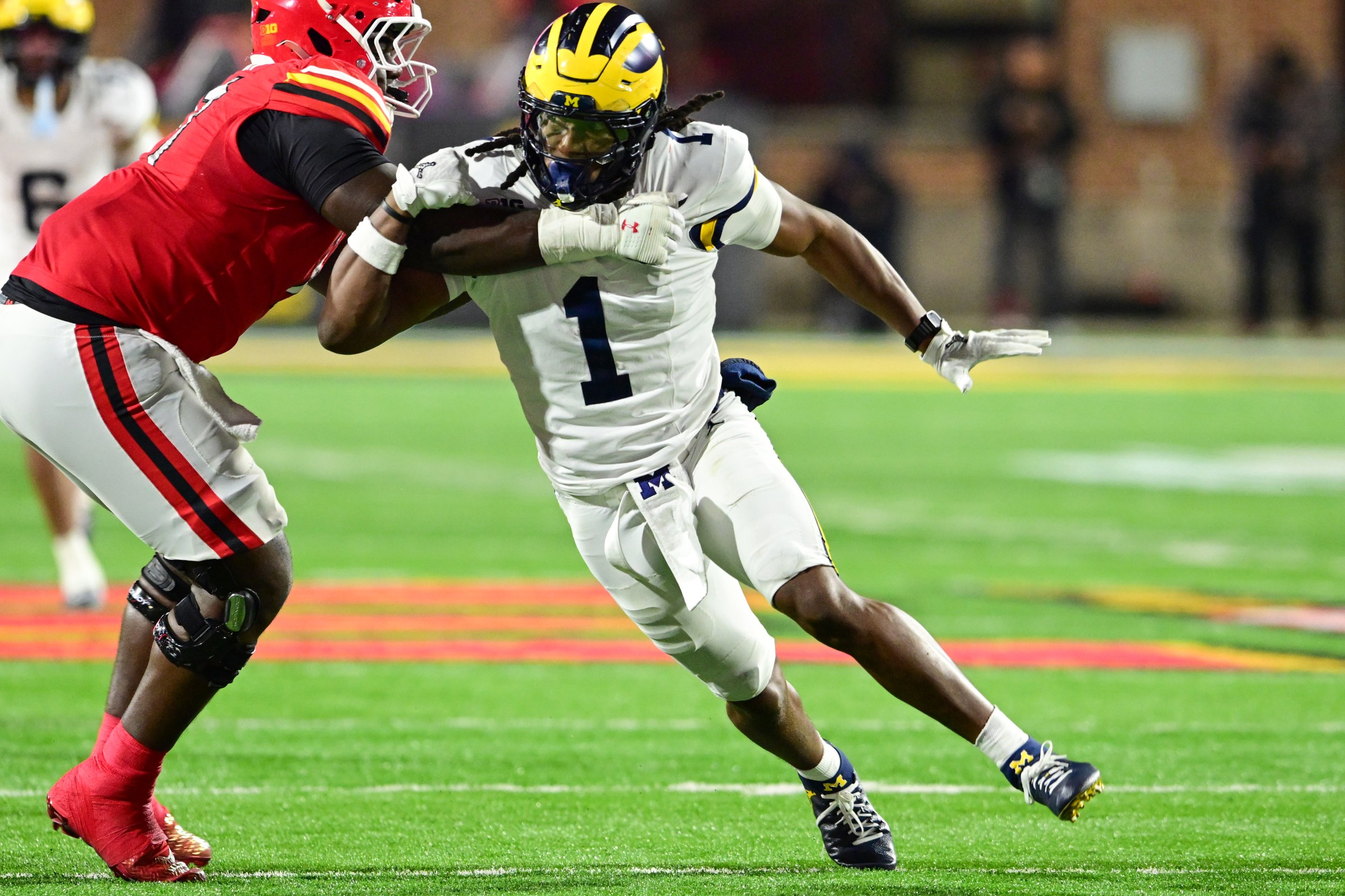 COLLEGE PARK, MARYLAND - NOVEMBER 22, 2025: Jaishawn Barham #1 of the Michigan Wolverines rushes against Alan Herron #71 of the Maryland Terrapins during the first half at SECU Stadium on November 22, 2025 in College Park, Maryland. (Photo by Chris Bernacchi/Diamond Images via Getty Images)