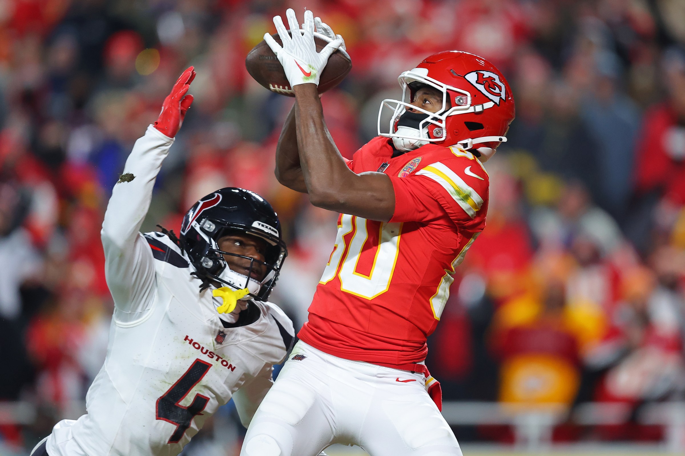 KANSAS CITY, MISSOURI - DECEMBER 07: Kamari Lassiter #4 of the Houston Texans breaks up a pass intended for Tyquan Thornton #80 of the Kansas City Chiefs during the third quarter at Arrowhead Stadium on December 07, 2025 in Kansas City, Missouri. (Photo by David Eulitt/Getty Images)
