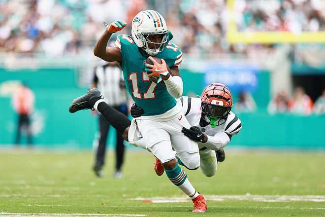 MIAMI GARDENS, FLORIDA - DECEMBER 21: Jordan Battle #27 of the Cincinnati Bengals tackles Jaylen Waddle #17 of the Miami Dolphins in the second quarter of a game at Hard Rock Stadium on December 21, 2025 in Miami Gardens, Florida. (Photo by Carmen Mandato/Getty Images)
