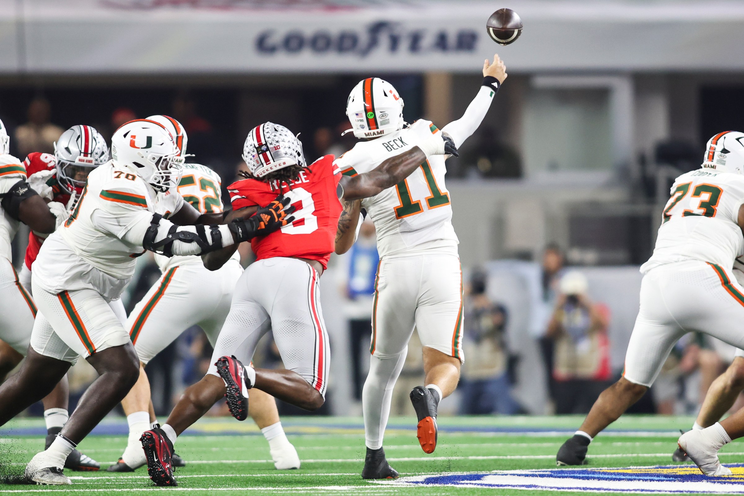 ARLINGTON, TEXAS - DECEMBER 31: Arvell Reese #8 of the Ohio State Buckeyes pressures Carson Beck #11 of the Miami Hurricanes on a throw in the first half during the College Football Playoff Quarter Final Game at AT&T Stadium on December 31, 2025 in Arlington, Texas. (Photo by CFP/Getty Images)
