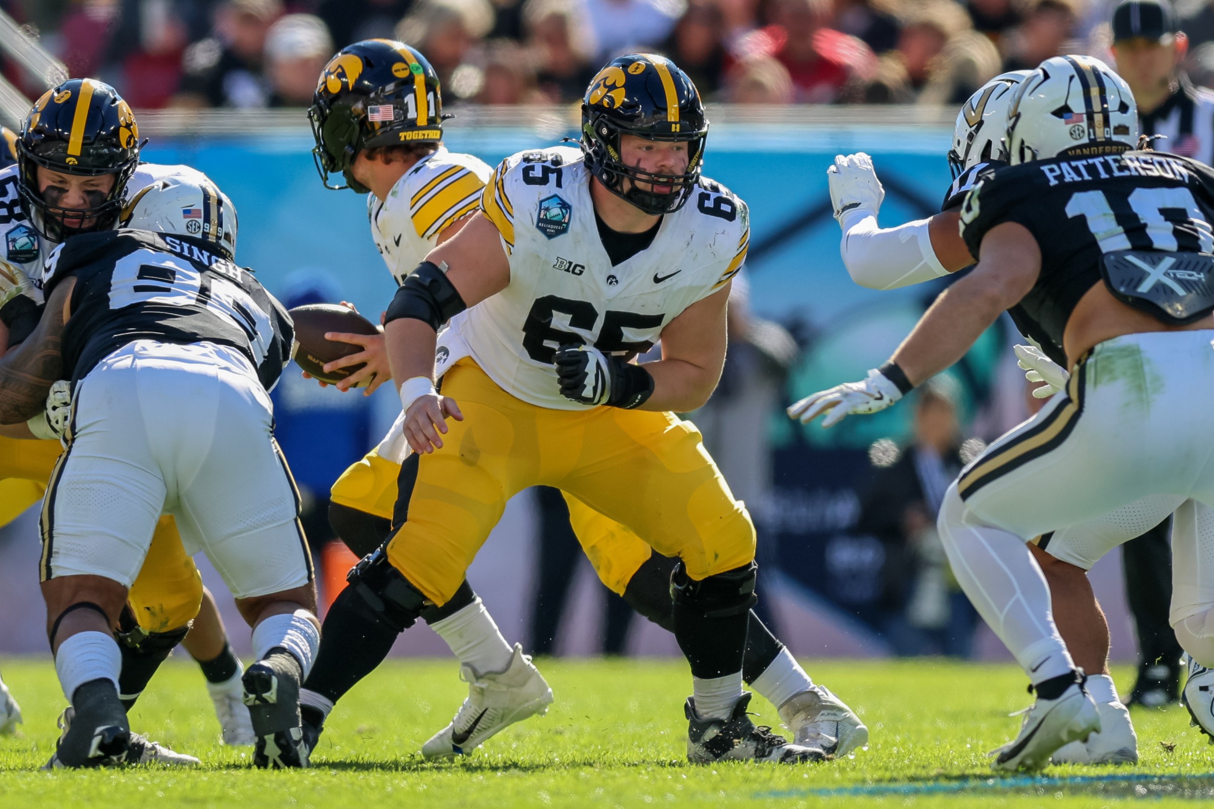 TAMPA, FLORIDA - DECEMBER 31: Logan Jones #65 of the Iowa Hawkeyes blocks against the Vanderbilt Commodores during the second half of the ReliaQuest Bowl at Raymond James Stadium on December 31, 2025 in Tampa, Florida. (Photo by Mike Carlson/Getty Images)