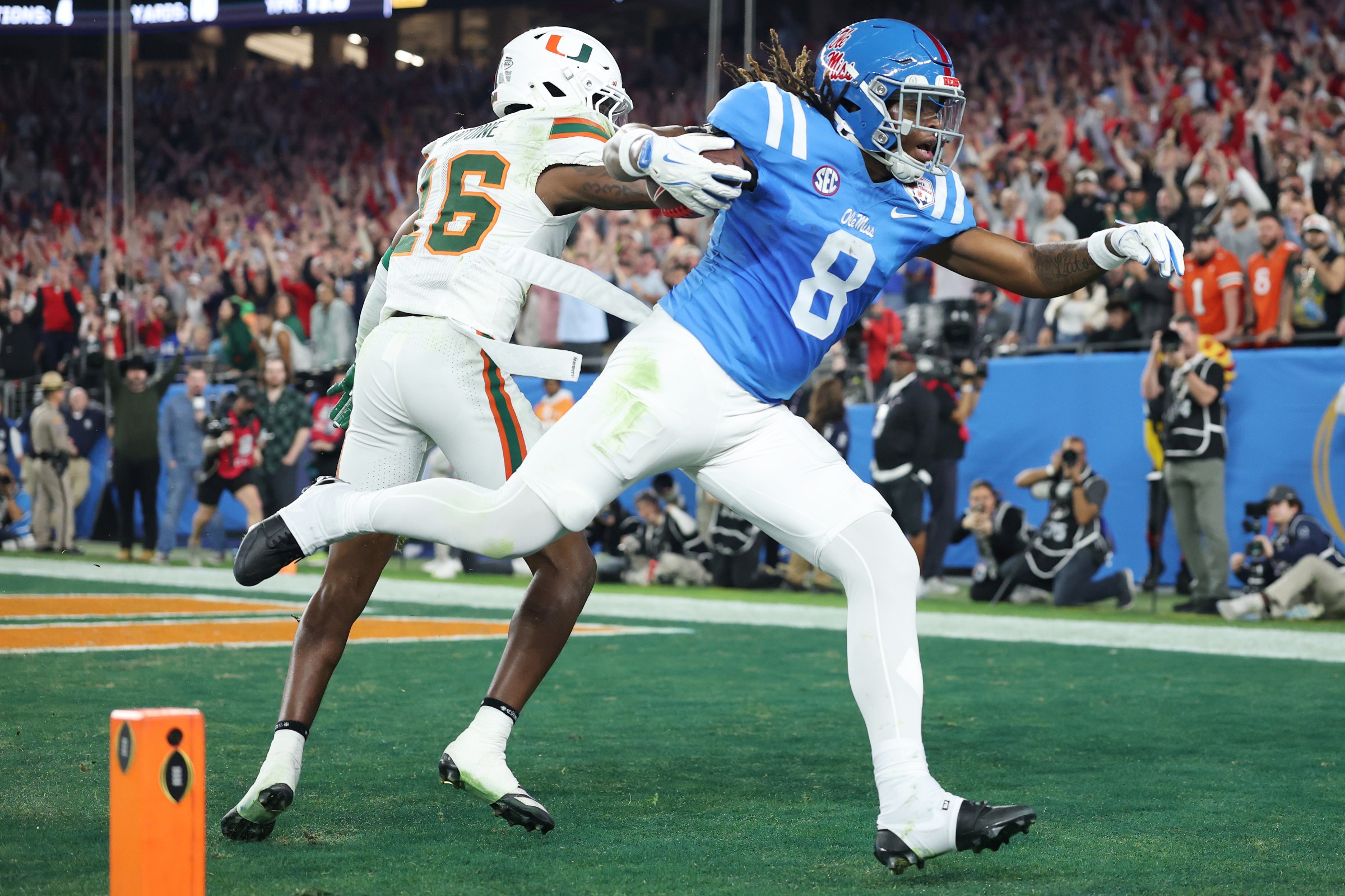 GLENDALE, ARIZONA - JANUARY 08: Dae’quan Wright #8 of the Ole Miss Rebels makes a catch for a touchdown defended by Jaboree Antoine #16 of the Miami Hurricanes in the fourth quarter during the 2025 College Football Playoff Semifinal at the VRBO Fiesta Bowl at State Farm Stadium on January 08, 2026 in Glendale, Arizona. (Photo by Christian Petersen/Getty Images)