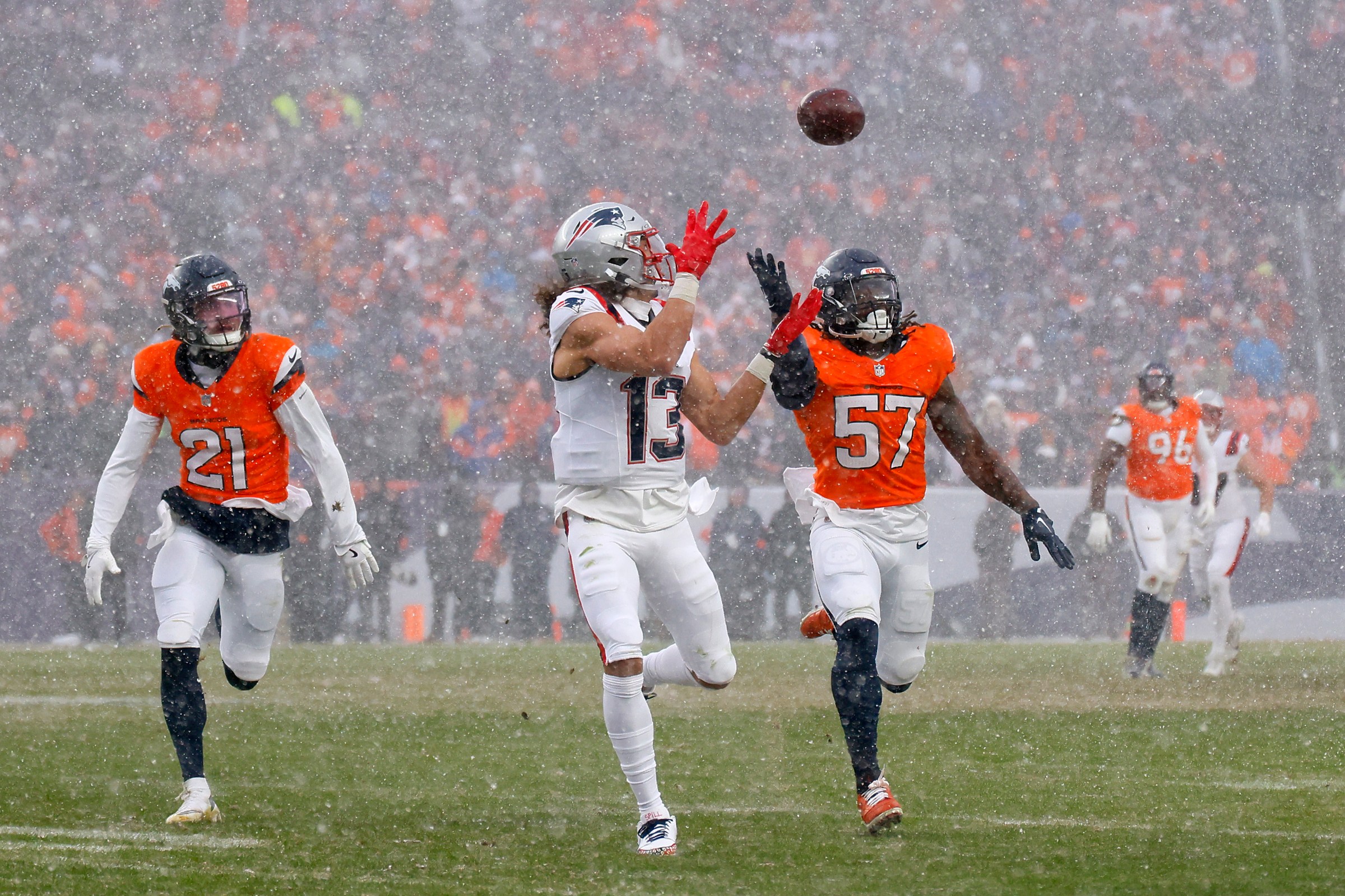 DENVER, COLORADO - JANUARY 25: Mack Hollins #13 of the New England Patriots makes a catch against Dre Greenlaw #57 of the Denver Broncos during the third quarter in the AFC Championship Playoff game at Empower Field At Mile High on January 25, 2026 in Denver, Colorado. (Photo by Justin Edmonds/Getty Images)