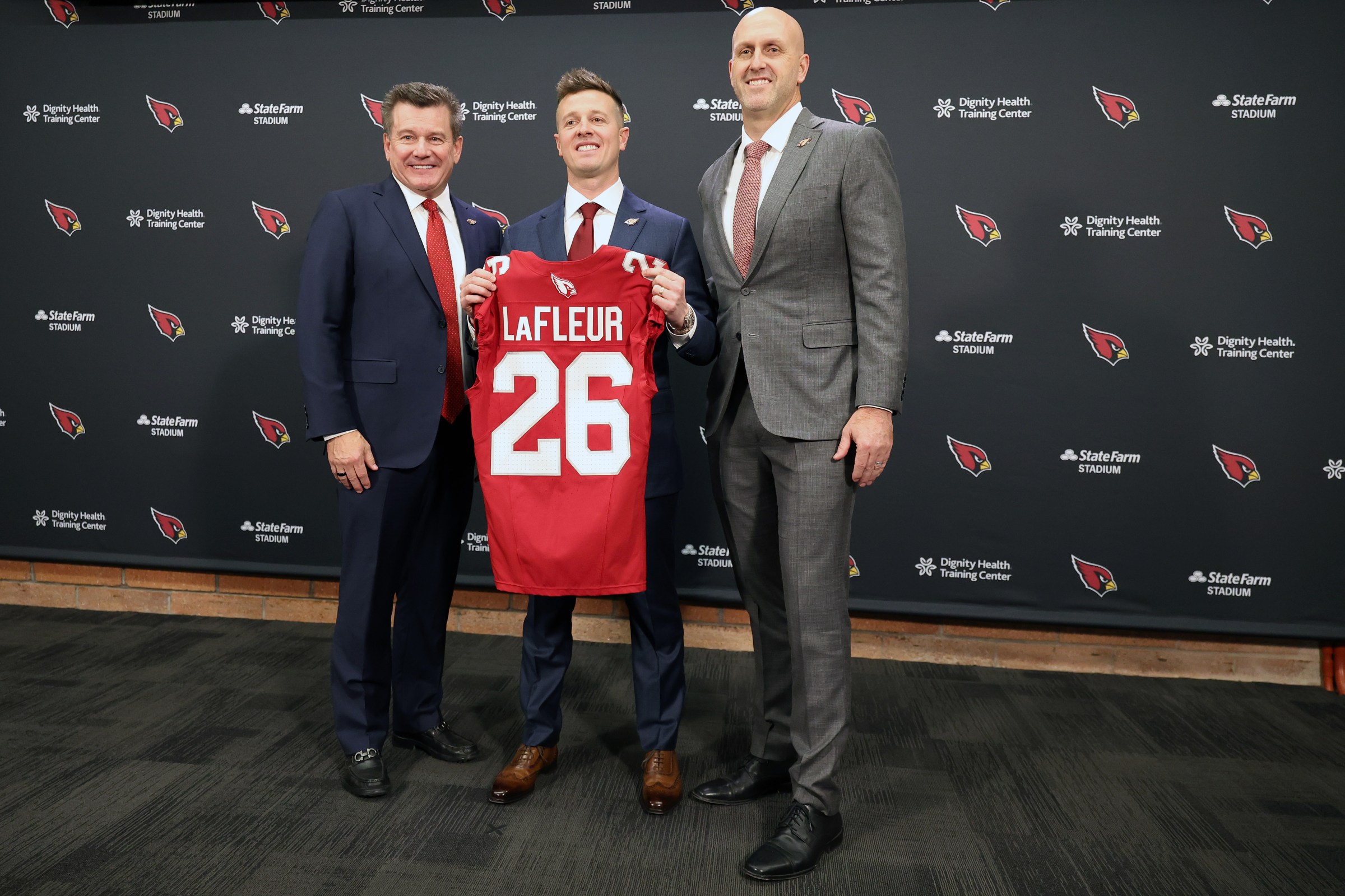 TEMPE, ARIZONA - FEBRUARY 03: (L-R) Arizona Cardinals owner Michael Bidwill, new head coach Mike LaFleur and general manager Monti Ossenfort of the Arizona Cardinals pose for a photo during a press conference at Dignity Health Arizona Cardinals Training Center on February 03, 2026 in Tempe, Arizona. (Photo by Chris Coduto/Getty Images)