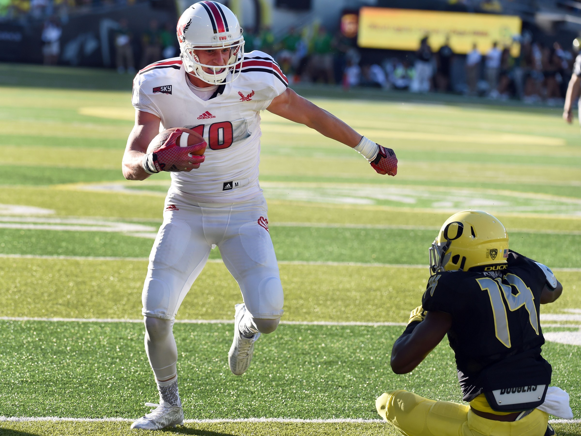 EUGENE, OR - SEPTEMBER 05: Wide receiver Cooper Kupp #10 of the Eastern Washington Eagles stiff arms cornerback Ugo Amadi #14 of the Oregon Ducks on the way to touchdown during the second quarter of the game against the Oregon Ducks at Autzen Stadium on September 5, 2015 in Eugene, Oregon. (Photo by Steve Dykes/Getty Images)