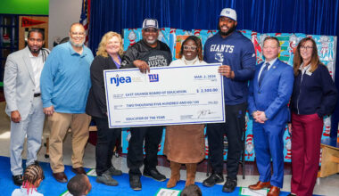 Andrew Thomas presents NJEA Educator of the Year Award to East Orange’s Mark Richards