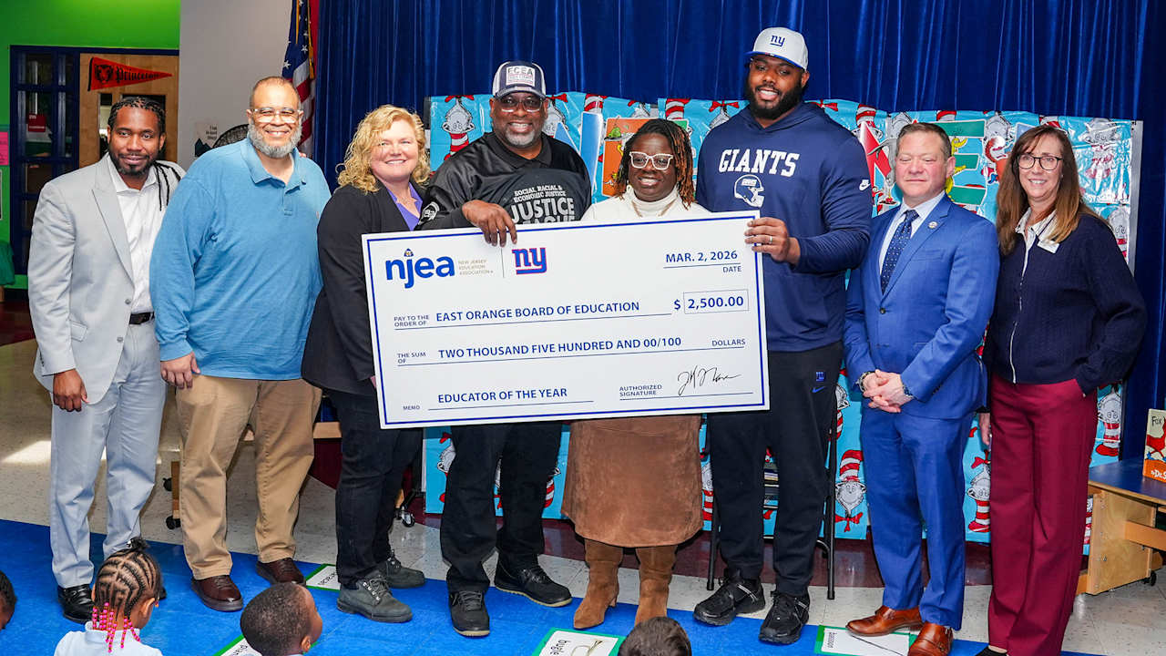 Andrew Thomas presents NJEA Educator of the Year Award to East Orange’s Mark Richards