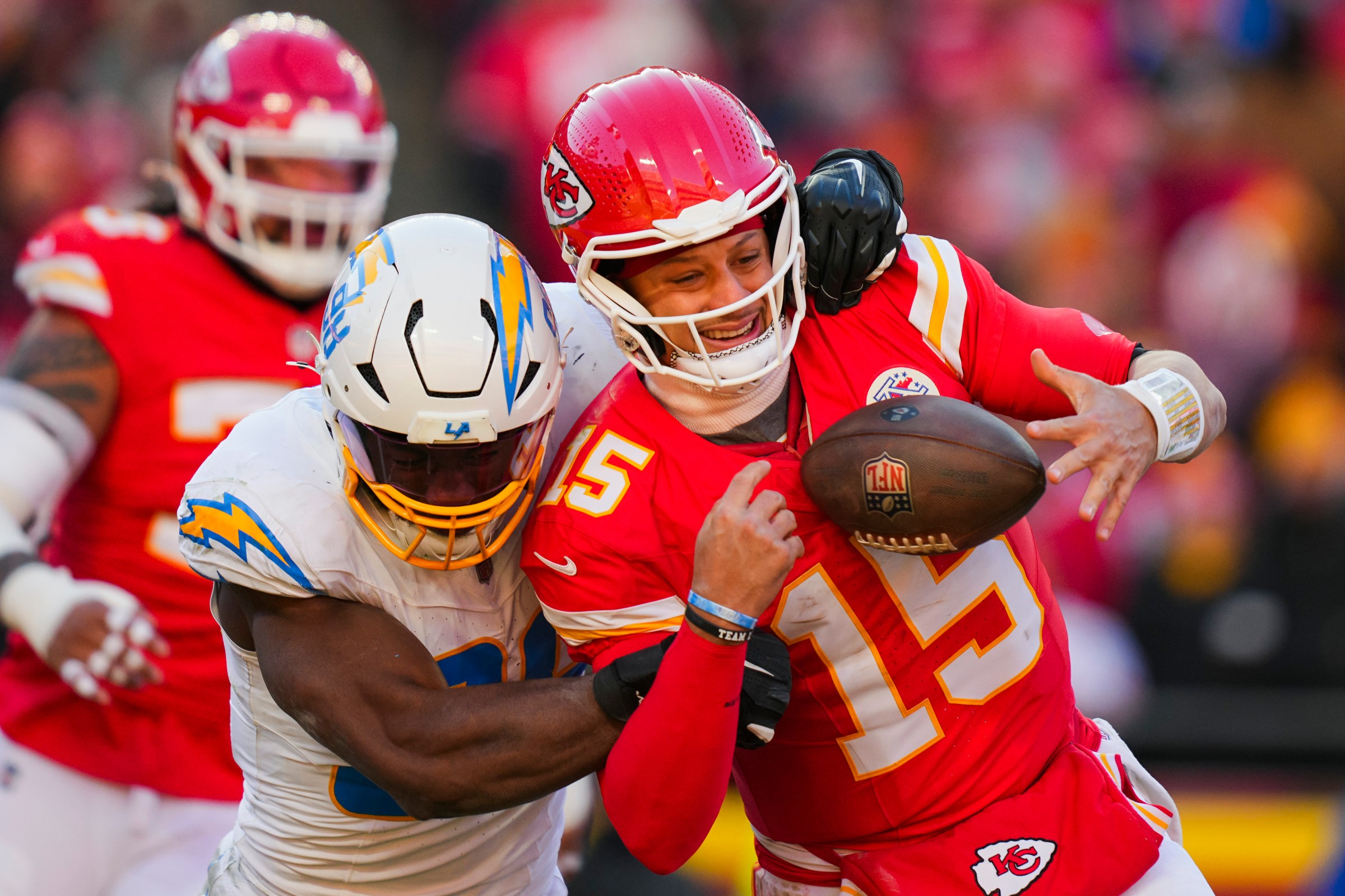 Dec 14, 2025; Kansas City, Missouri, USA; Kansas City Chiefs quarterback Patrick Mahomes (15) is sacked by Los Angeles Chargers linebacker Odafe Oweh (98) during the second half at GEHA Field at Arrowhead Stadium. Mandatory Credit: Jay Biggerstaff-Imagn Images