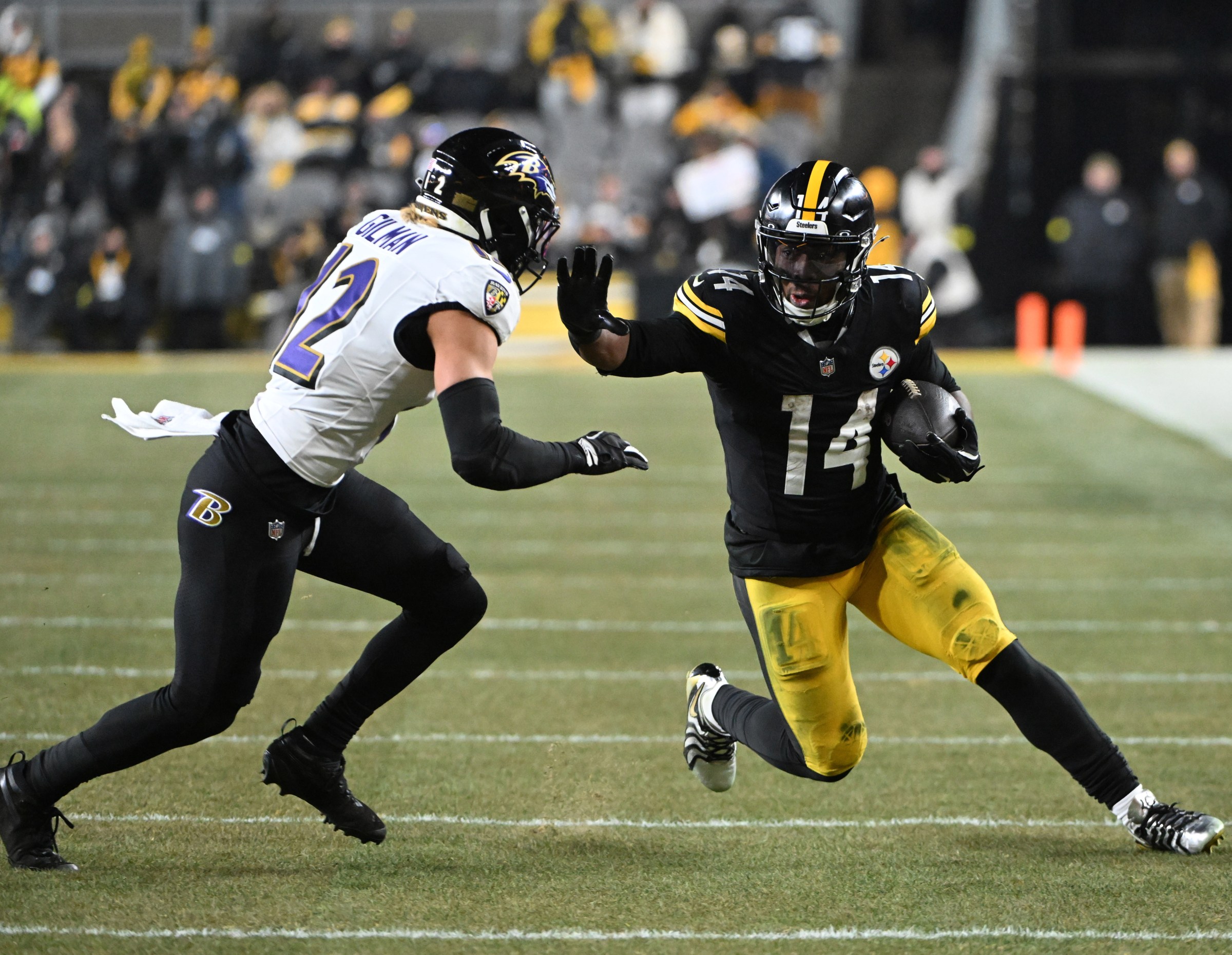 Jan 4, 2026; Pittsburgh, Pennsylvania, USA; Pittsburgh Steelers running back Kenneth Gainwell (14) rushes the ball against Baltimore Ravens safety Alohi Gilman (12) during the first half at Acrisure Stadium. Mandatory Credit: Barry Reeger-Imagn Images