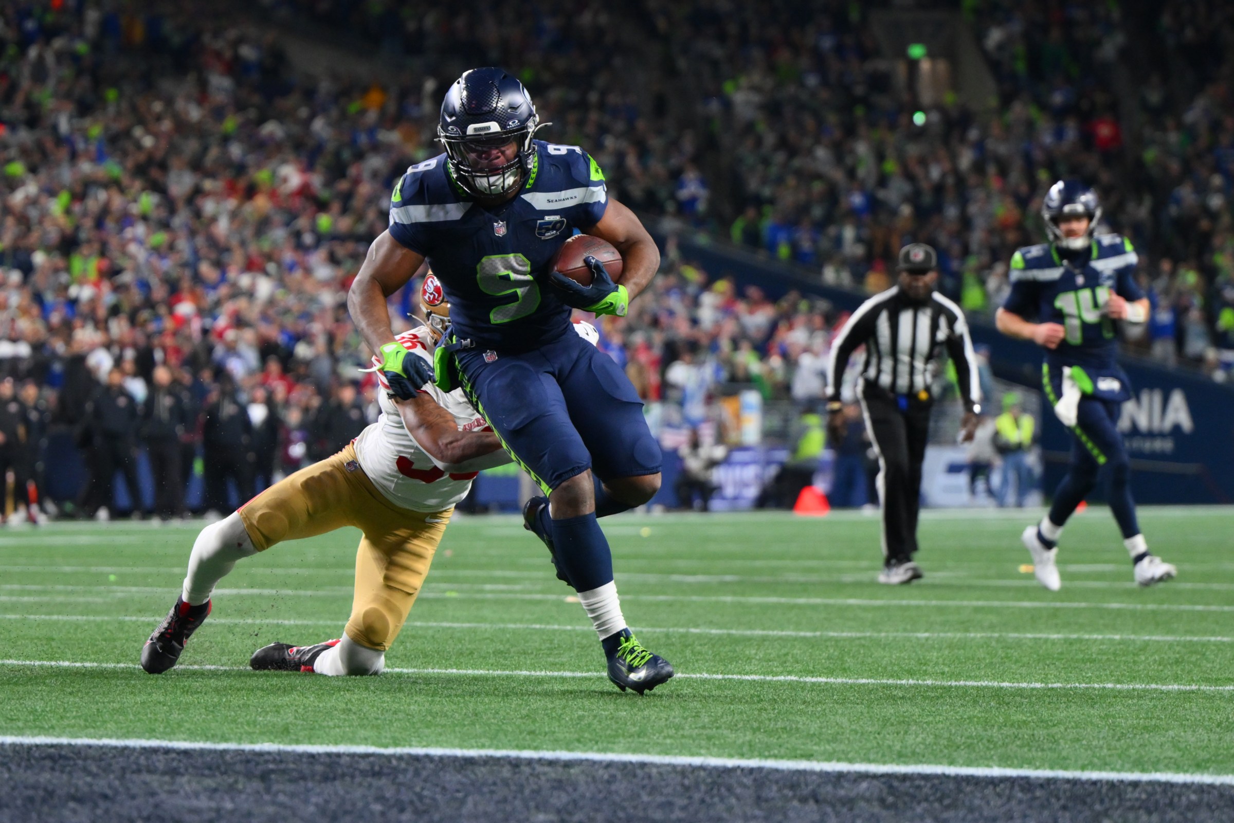 Jan 17, 2026; Seattle, WA, USA; Seattle Seahawks running back Kenneth Walker III (9) carries the ball for a touchdown as San Francisco 49ers safety Marques Sigle (36) defends during the first half in an NFC Divisional Round game at Lumen Field. Mandatory Credit: Steven Bisig-Imagn Images