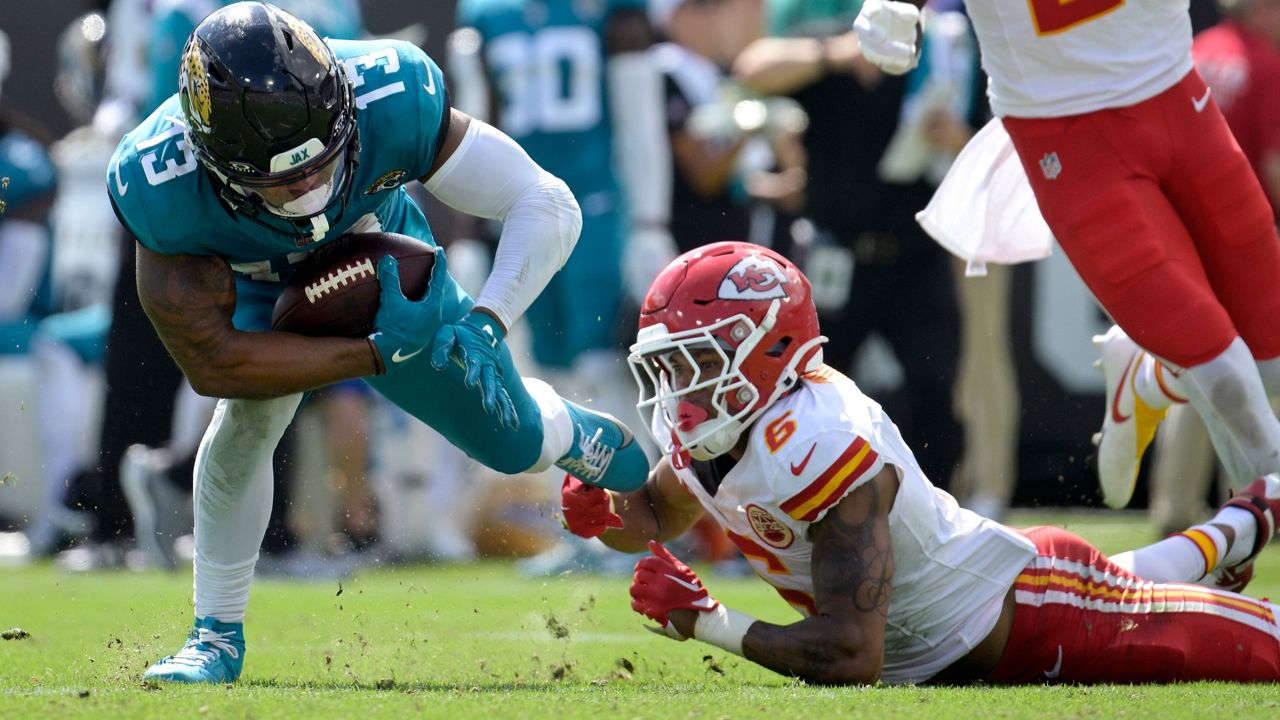 Jacksonville Jaguars wide receiver Christian Kirk (13) is tripped by Kansas City Chiefs safety Bryan Cook (6) during the second half of an NFL football game, Sunday, Sept. 17, 2023, in Jacksonville, Fla. (AP Photo/Phelan M. Ebenhack)