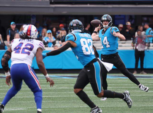 Carolina Panthers quarterback Andy Dalton looks down field to Tommy Tremble as Buffalo Bills Dorian Willliams waits for the ball on Oct. 26, 2025 at Bank of America Stadium in Charlotte.