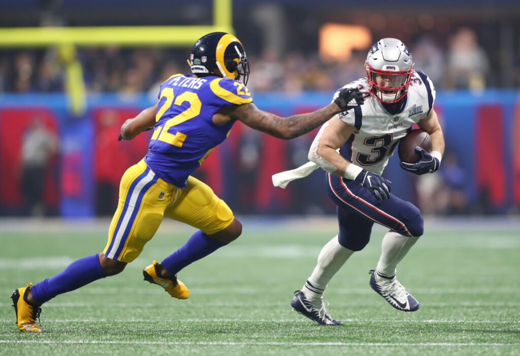 New England Patriots running back Rex Burkhead (34) runs against Los Angeles Rams cornerback Marcus Peters (22) in the fourth quarter in Super Bowl LIII at Mercedes-Benz Stadium.