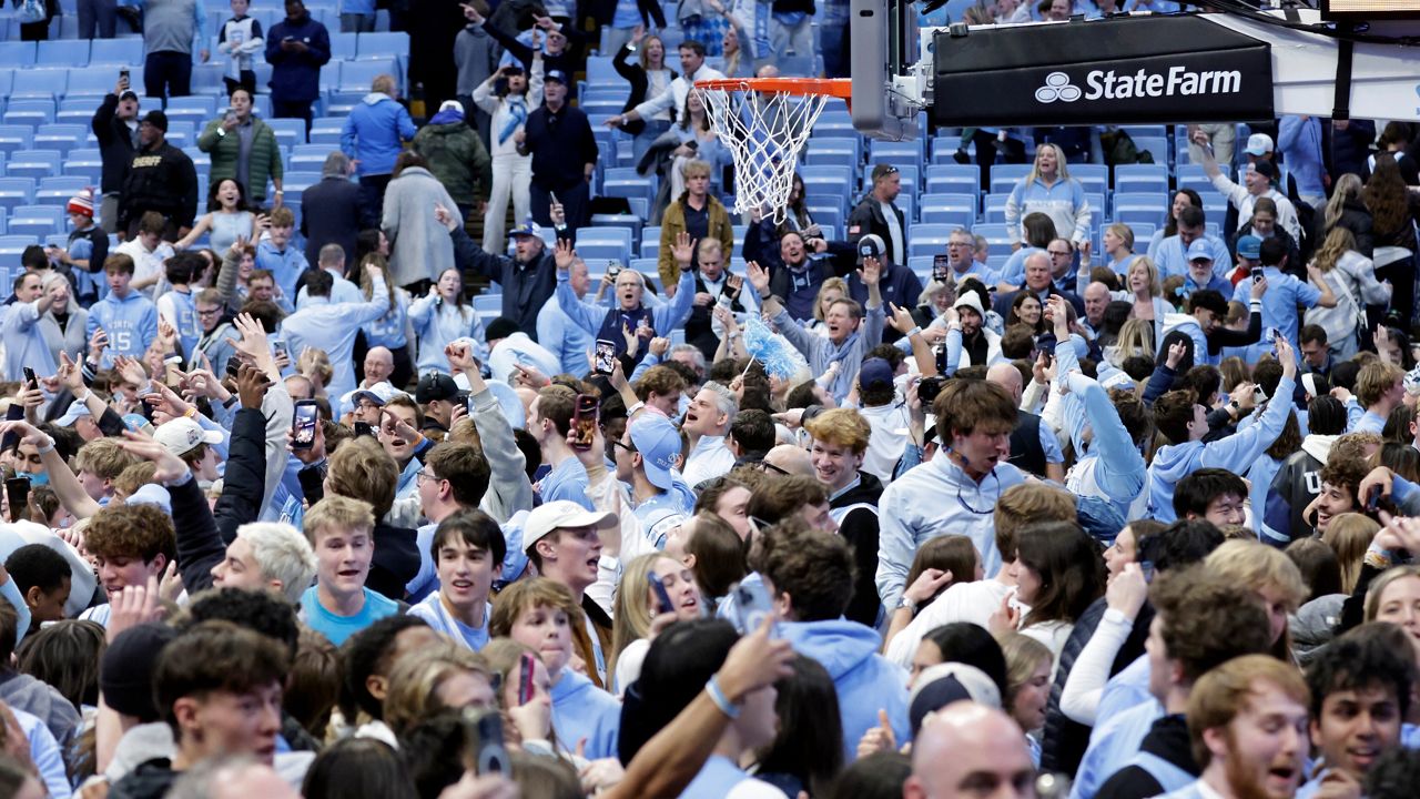 North Carolina fans take the floor and celebrate after the team defeated Duke in the final seconds of an NCAA college basketball game Saturday, Feb. 7, 2026, in Chapel Hill, N.C. (AP Photo/Chris Seward)