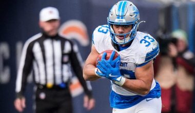 Detroit Lions running back Sione Vaki (33) runs against Chicago Bears linebacker Amen Ogbongbemiga (45) and defensive end Jacob Martin (55) during the second half at Soldier Field in Chicago, Ill. on Sunday, Dec. 22, 2024.