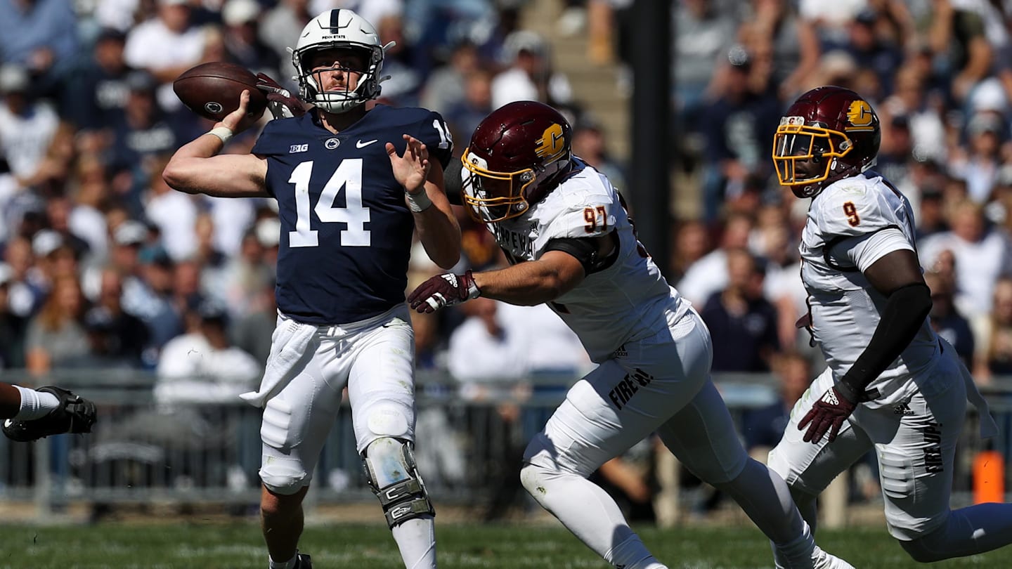 Sep 24, 2022; University Park, Pennsylvania, USA; Penn State Nittany Lions quarterback Sean Clifford (14) looks to throw a pass before being tackled by Central Michigan Chippewas defensive linesman Michael Heldman (97) during the second quarter at Beaver Stadium. Penn State defeated Central Michigan 33-14. Mandatory Credit: Matthew OHaren-Imagn Images