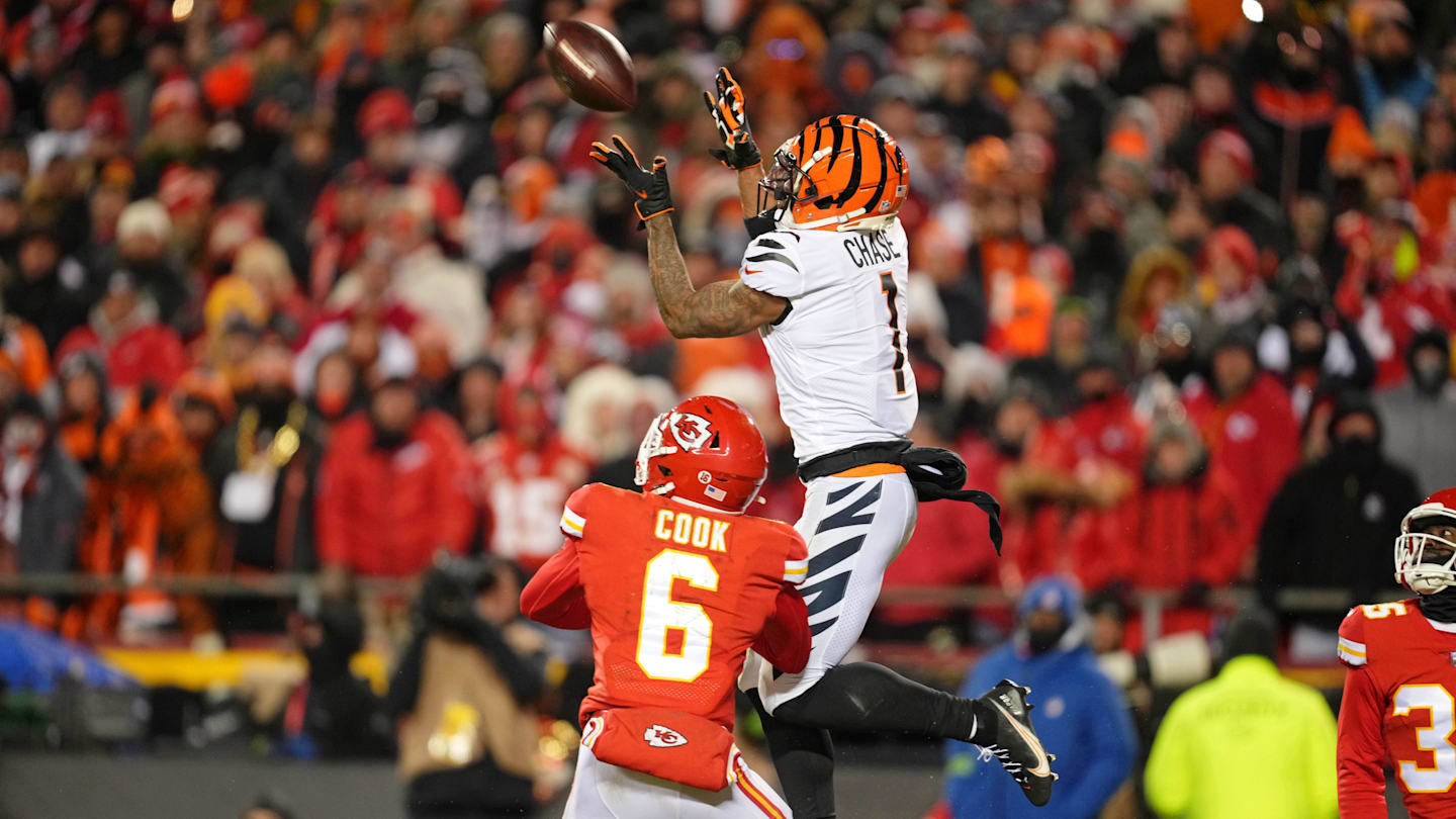 Jan 29, 2023; Kansas City, Missouri, USA; Cincinnati Bengals wide receiver Ja'Marr Chase (1) makes a catch against Kansas City Chiefs safety Bryan Cook (6) during the third quarter of the AFC Championship game at GEHA Field at Arrowhead Stadium. Mandatory Credit: Jay Biggerstaff-Imagn Images