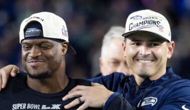 Former Seattle Seahawks running back Kenneth Walker III stands with head coach Mike Macdonald