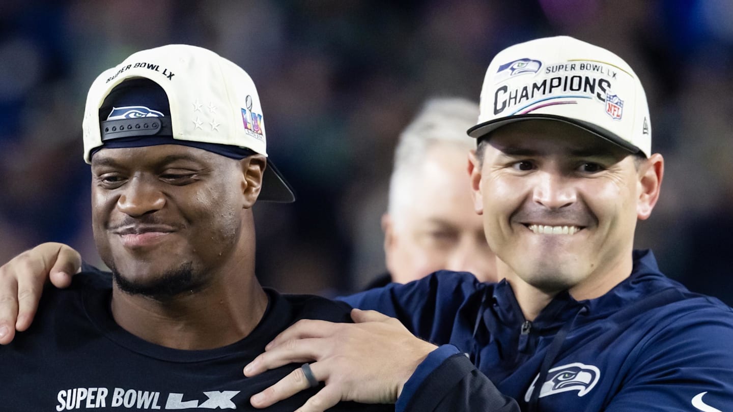 Former Seattle Seahawks running back Kenneth Walker III stands with head coach Mike Macdonald
