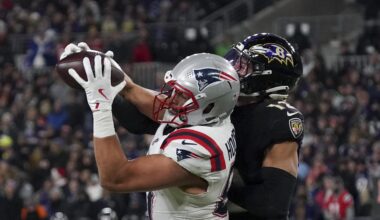 Dec 21, 2025; Baltimore, Maryland, USA;  New England Patriots tight end Austin Hooper (81) makes a catch against Baltimore Ravens safety Alohi Gilman (12) during the first half of the game at M&T Bank Stadium. Mandatory Credit: James Lang-Imagn Images