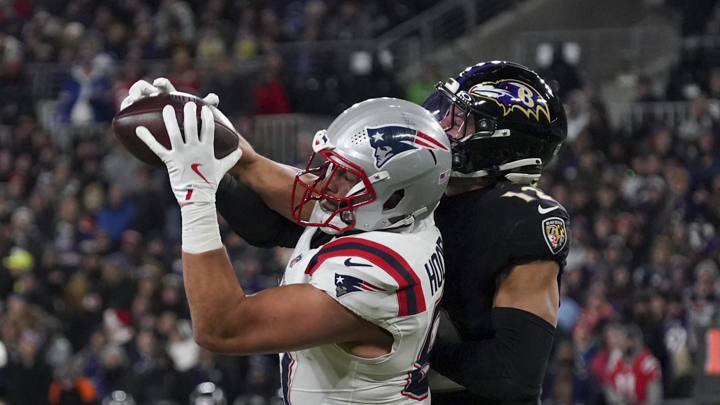 Dec 21, 2025; Baltimore, Maryland, USA;  New England Patriots tight end Austin Hooper (81) makes a catch against Baltimore Ravens safety Alohi Gilman (12) during the first half of the game at M&T Bank Stadium. Mandatory Credit: James Lang-Imagn Images