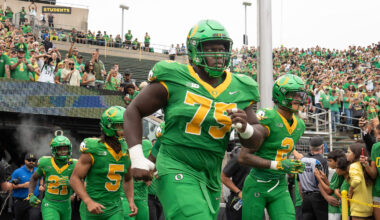 Oregon’s Emmanuel Pregnon, center, takes the field before the game against Oklahoma State at Autzen.