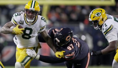 Green Bay Packers running back Josh Jacobs (8) is tackled by Chicago Bears defensive tackle Andrew Billings (97) during the second quarter of their wild card playoff game Saturday, January 10, 2026 at Soldier Field in Chicago, Illinois.