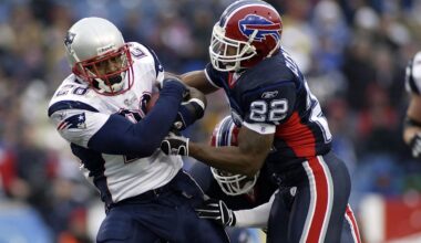 Dec 11, 2005; Orchard Park, NY, USA; FILE PHOTO; New England Patriots running back Corey Dillon (28) carries the ball as he is chased by Buffalo Bills defensive back Nate Clements (22) at Ralph Wilson Stadium. The Patriots defeated the Bills 35-7. Mandatory Credit: MPS-Imagn Images
