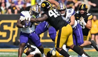 Oct 12, 2024; Iowa City, Iowa, USA; Washington Huskies running back Jonah Coleman (1) is tackled by Iowa Hawkeyes defensive lineman Deontae Craig (45) as tight end Keleki Latu (85) looks to block during the fourth quarter at Kinnick Stadium. Mandatory Credit: Jeffrey Becker-Imagn Images