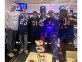 Buffalo Bills International Fan of the Year Darryl Russell (in suit) poses with fellow fans.